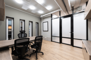 an office painted in a light green with black trim